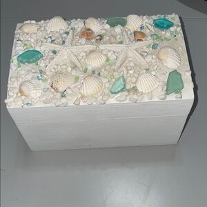 White wooden keepsake box with seashore decor on top